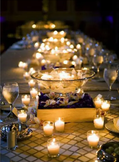 Glass bowl with floating candles and rose petals