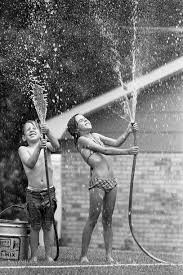 Kids playing with water hoses