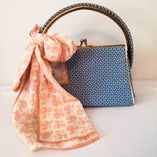 Blue handbag with orange scarf