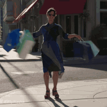 Woman twirling with shopping bags