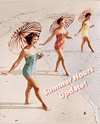 Women in vintage bathing suits holding umbrellas