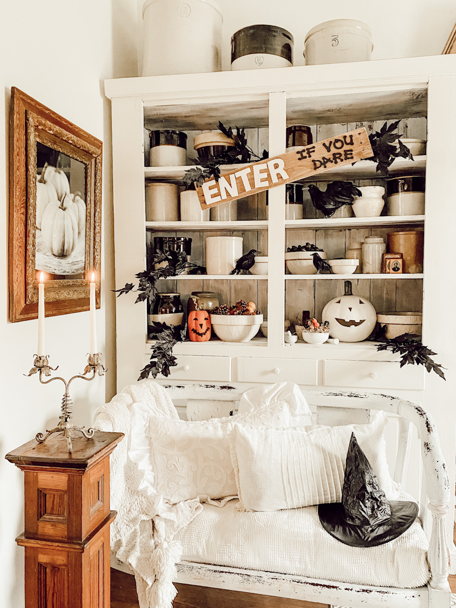 White china hutch with halloween decorations